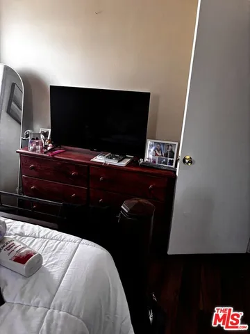 a room with a bed and television