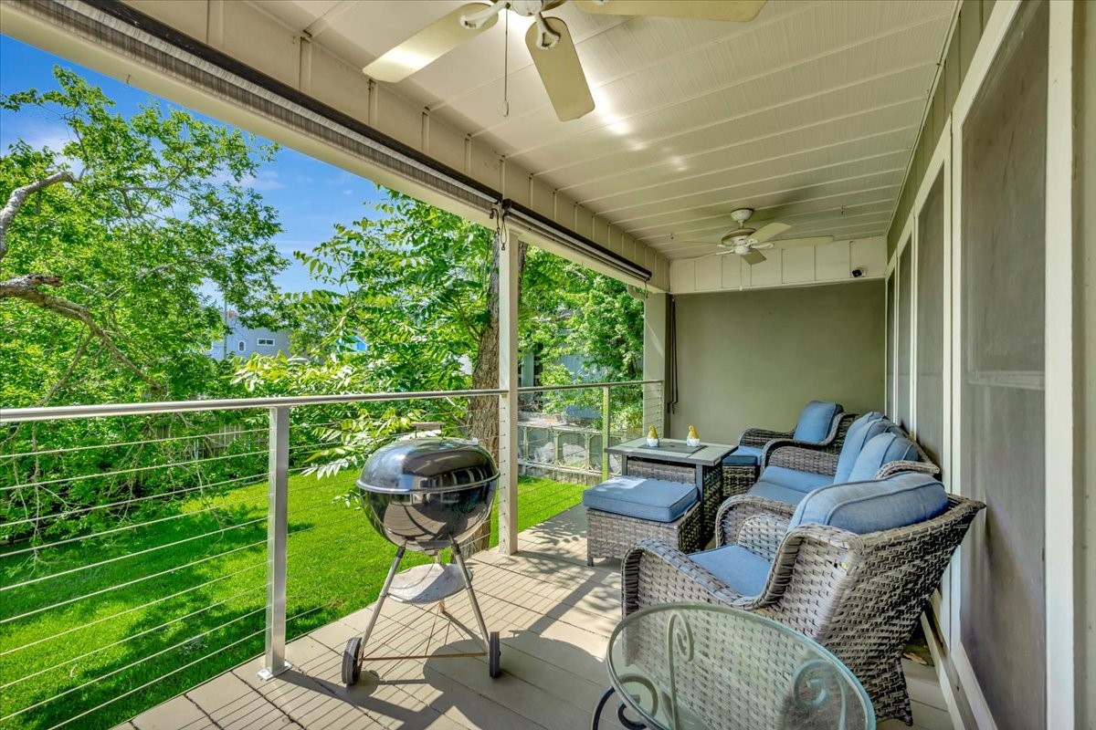 112 Oak Road Clear Lake Shores, TX 77565 - Photo 3 of 41 REAR BALCONY OVERLOOKING THE TREE COVERED BACKYARD.