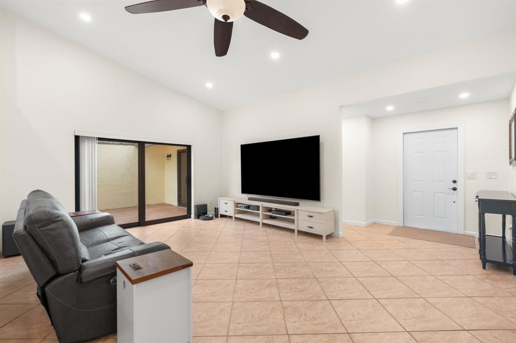 9106 Southwest 22nd Street, Unit D Boca Raton, FL 33428 - Photo 14 of 41 a living room with furniture and a flat screen tv