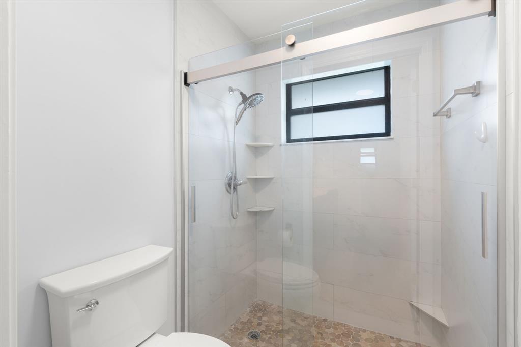 9106 Southwest 22nd Street, Unit D Boca Raton, FL 33428 - Photo 21 of 41 a bathroom with a shower and a toilet