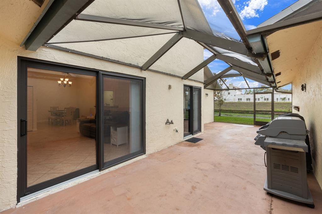 9106 Southwest 22nd Street, Unit D Boca Raton, FL 33428 - Photo 25 of 41 a view of a porch with a door and a porch