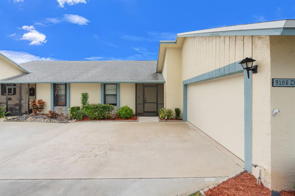 9106 Southwest 22nd Street, Unit D Boca Raton, FL 33428 - Photo 3 of 41 a front view of a house with yard