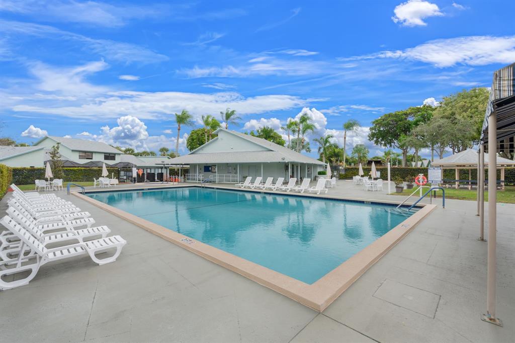 9106 Southwest 22nd Street, Unit D Boca Raton, FL 33428 - Photo 39 of 41 a view of a swimming pool with a lake view