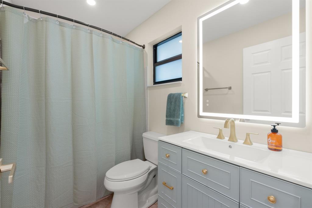 9106 Southwest 22nd Street, Unit D Boca Raton, FL 33428 - Photo 41 of 41 a bathroom with a granite countertop sink and a toilet