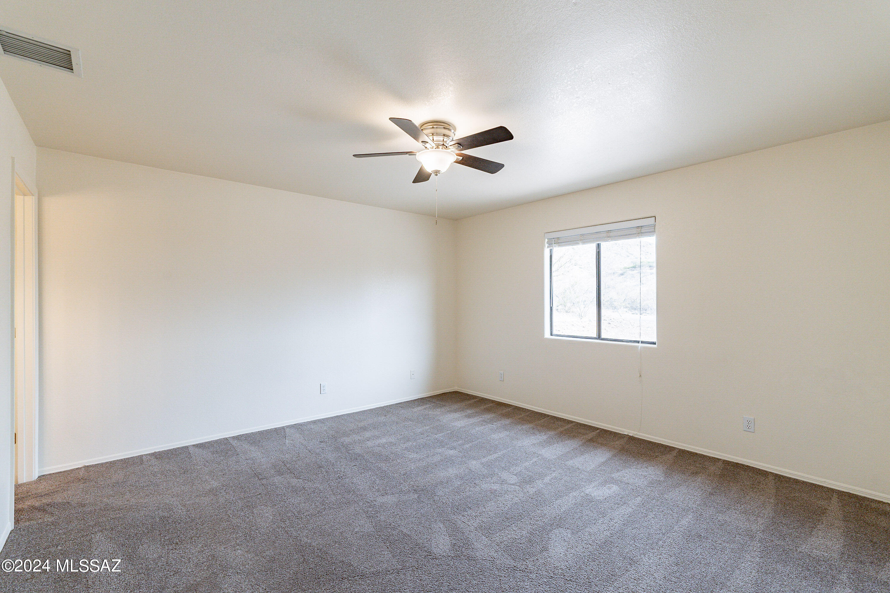 1380 Camino Faja Rio Rico, AZ 85648 - Photo 15 of 28 a view of a room with a ceiling fan and a window