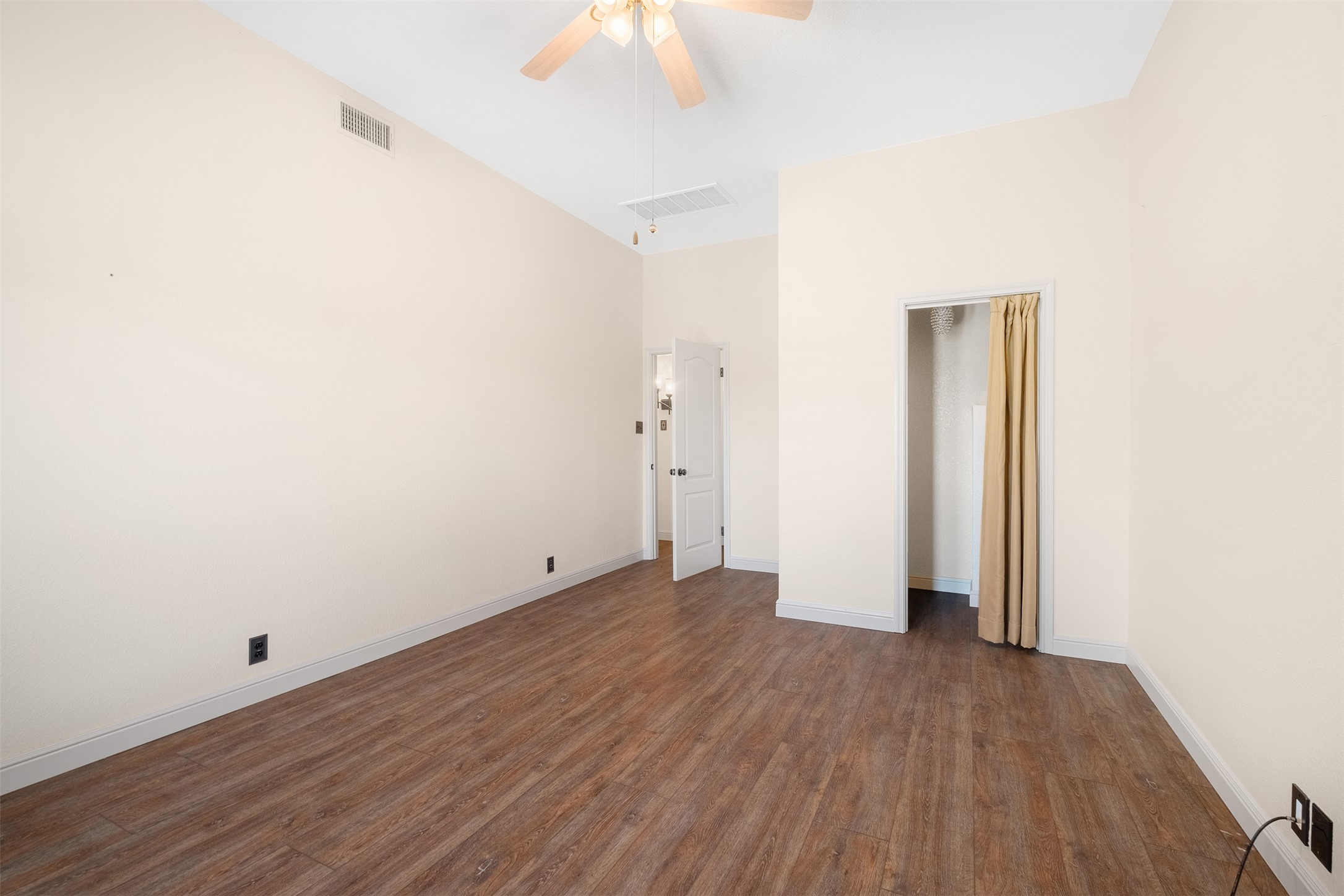 360 Sunset Ridge Drive Liberty Hill, TX 78642 - Photo 25 of 40 an empty room with wooden floor and a ceiling fan