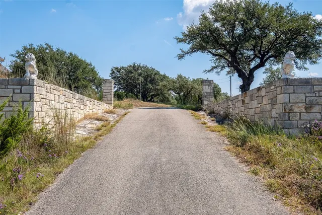 a view of a pathway with a wrought fence