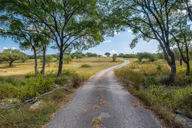 a view of a lake with trees in the background