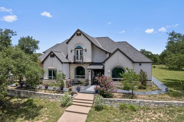 a front view of a house with garden