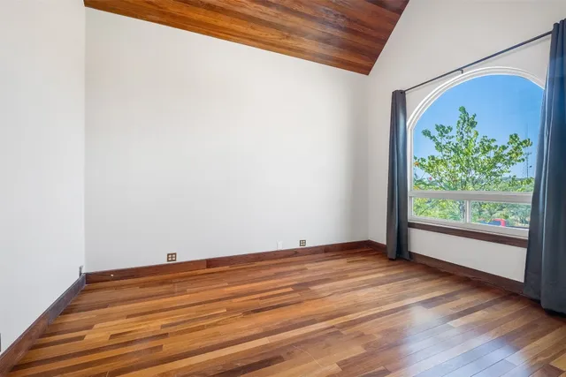a view of room with window and wooden floor