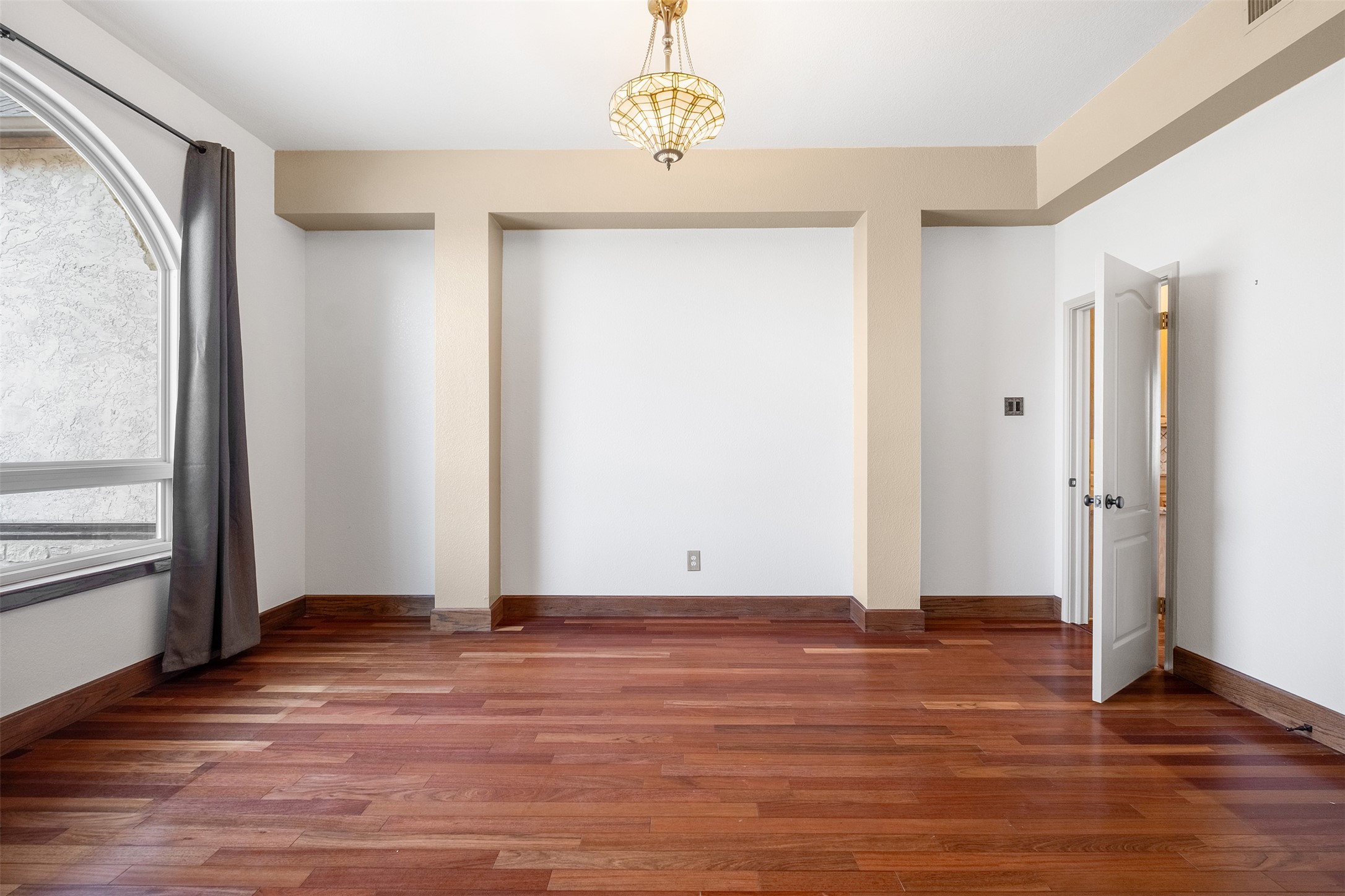 360 Sunset Ridge Drive Liberty Hill, TX 78642 - Photo 10 of 40 a view of an empty room with wooden floor and a window