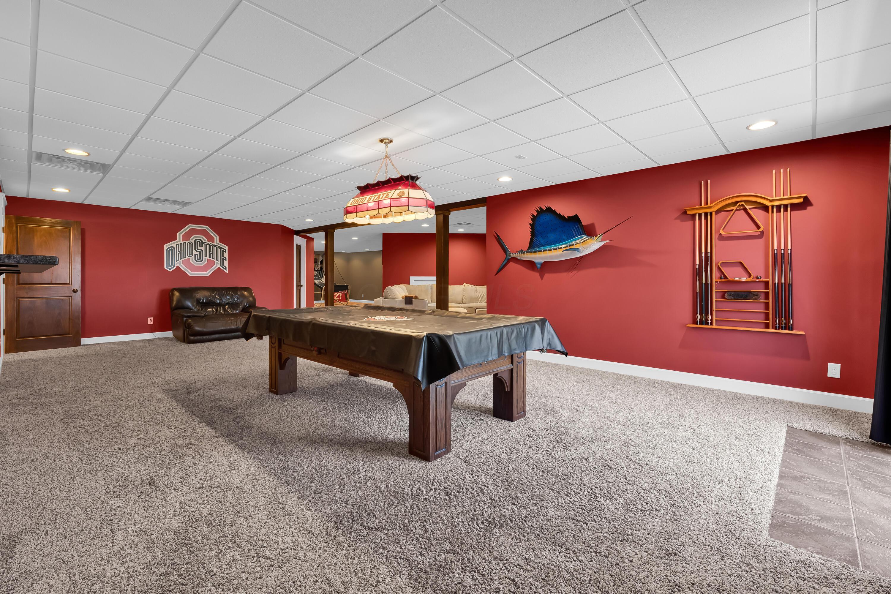 16689 Bailor Road Laurelville, OH 43135 - Photo 48 of 73 • Light sand carpet
• Burgundy painted walls
• Pool table & light remains
• Double sliding doors to
paver patio
• Closet with double sliding doors