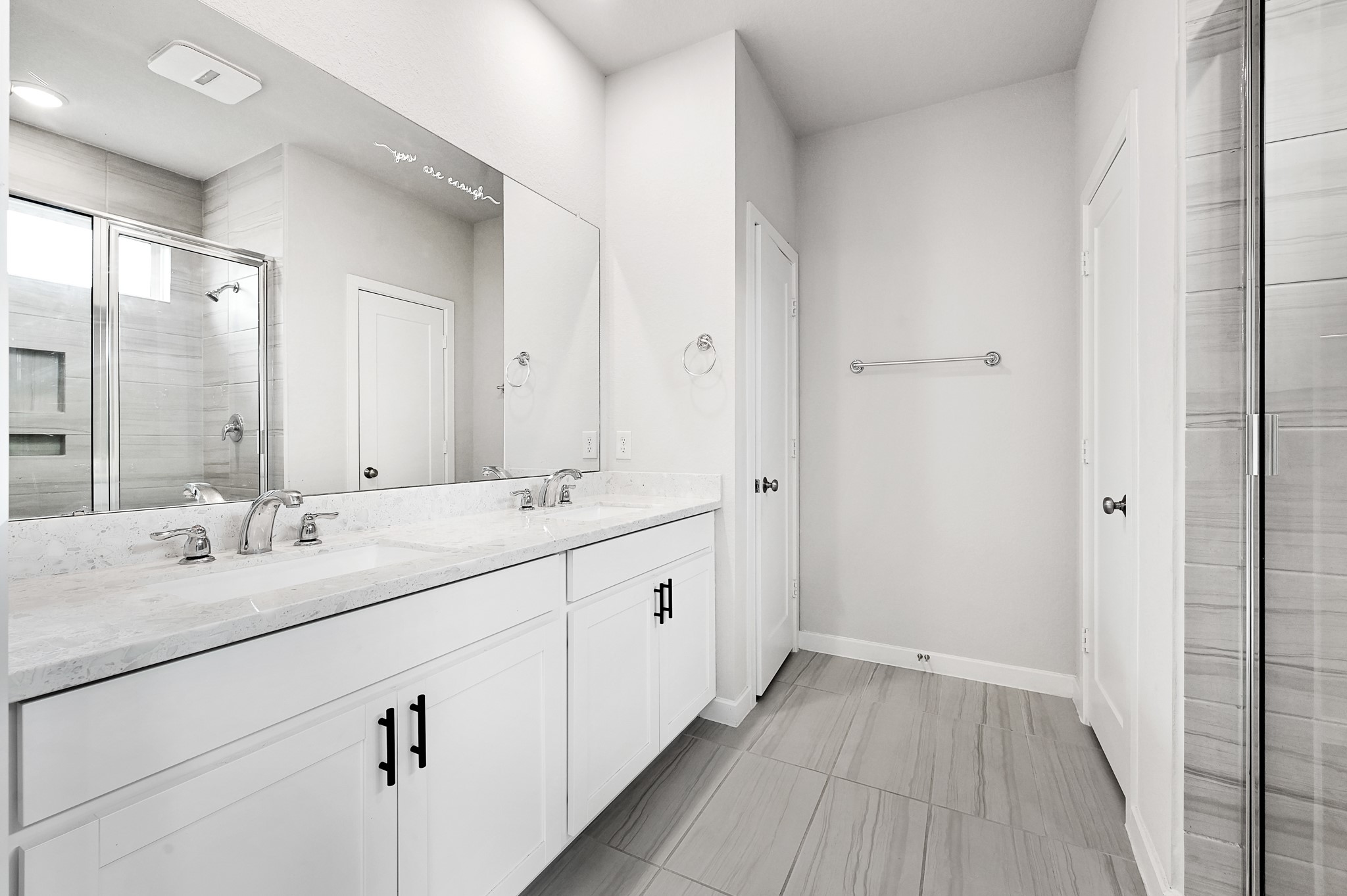 9119 Brixham Drive Cypress, TX 77433 - Photo 17 of 23 a bathroom with a double vanity sink and mirror