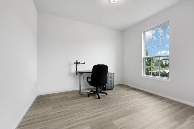 a view of workspace with wooden floor windows