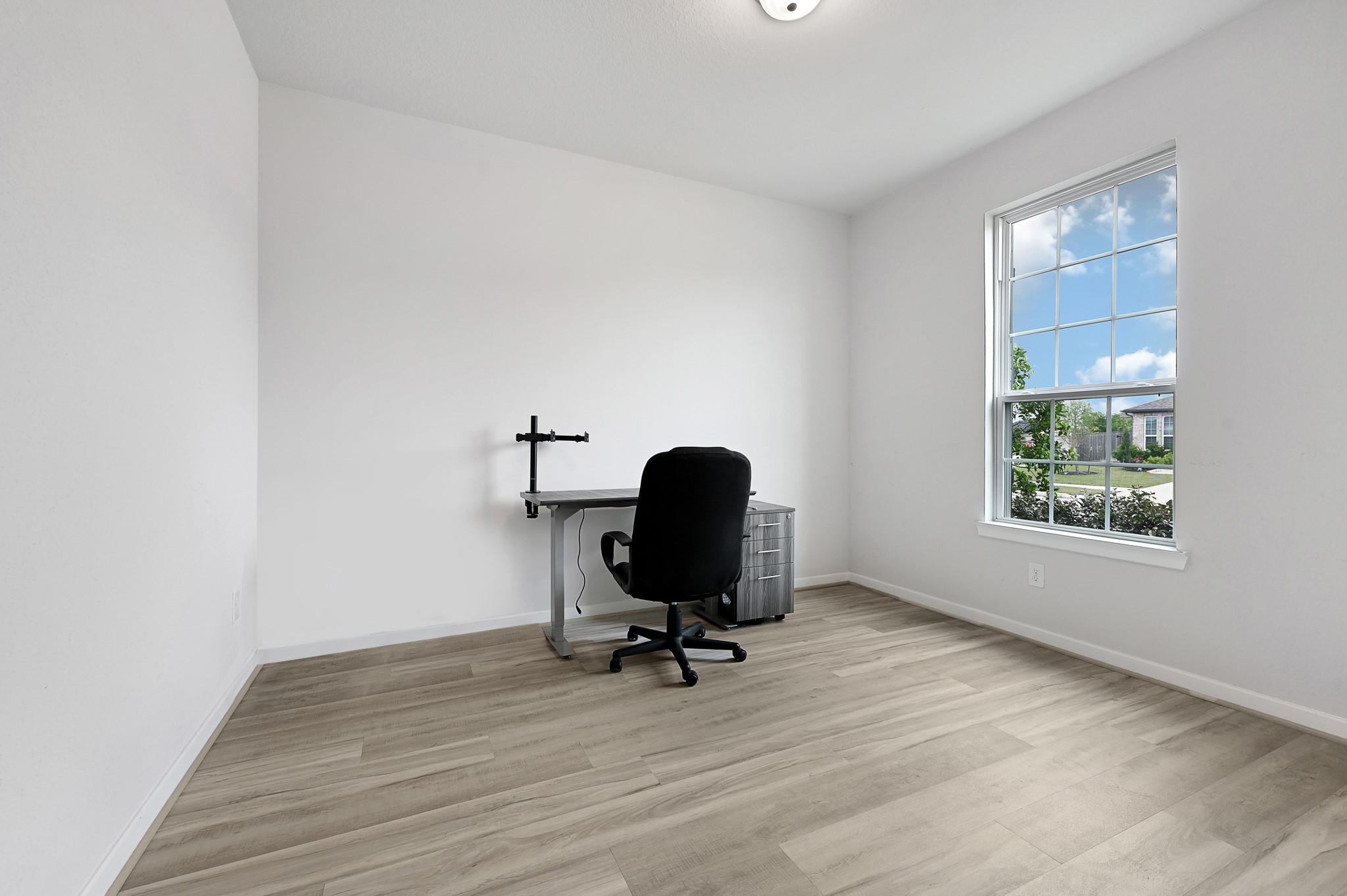 9119 Brixham Drive Cypress, TX 77433 - Photo 3 of 23 a view of workspace with wooden floor windows