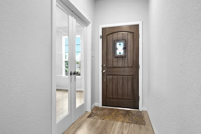 a view of a hallway with wooden floor