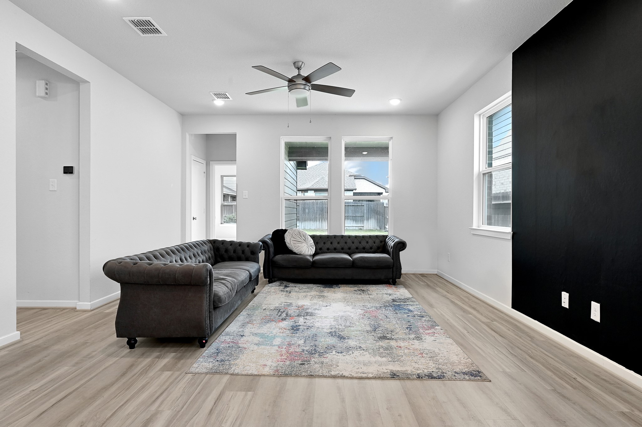 9119 Brixham Drive Cypress, TX 77433 - Photo 5 of 23 a living room with furniture and a wooden floor