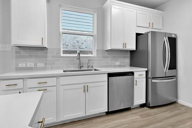 a kitchen with stainless steel appliances white cabinets and a granite counter tops