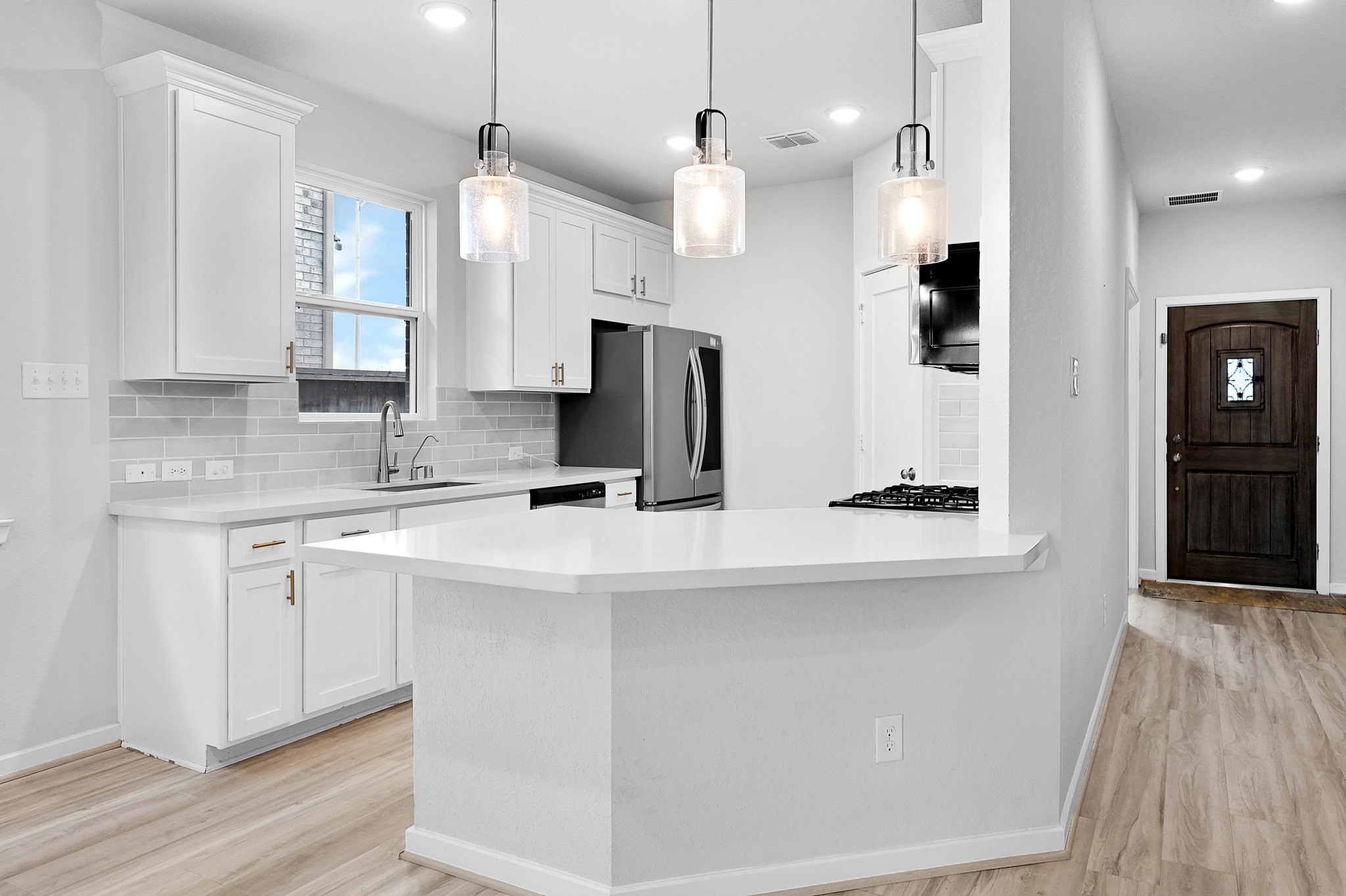 9119 Brixham Drive Cypress, TX 77433 - Photo 8 of 23 a kitchen with stainless steel appliances sink refrigerator and microwave