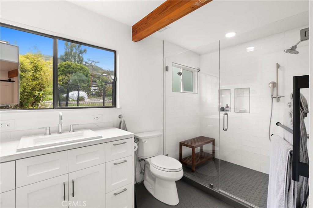 645 Griffith Way Laguna Beach, CA 92651 - Photo 21 of 46 a bathroom with a toilet sink and mirror