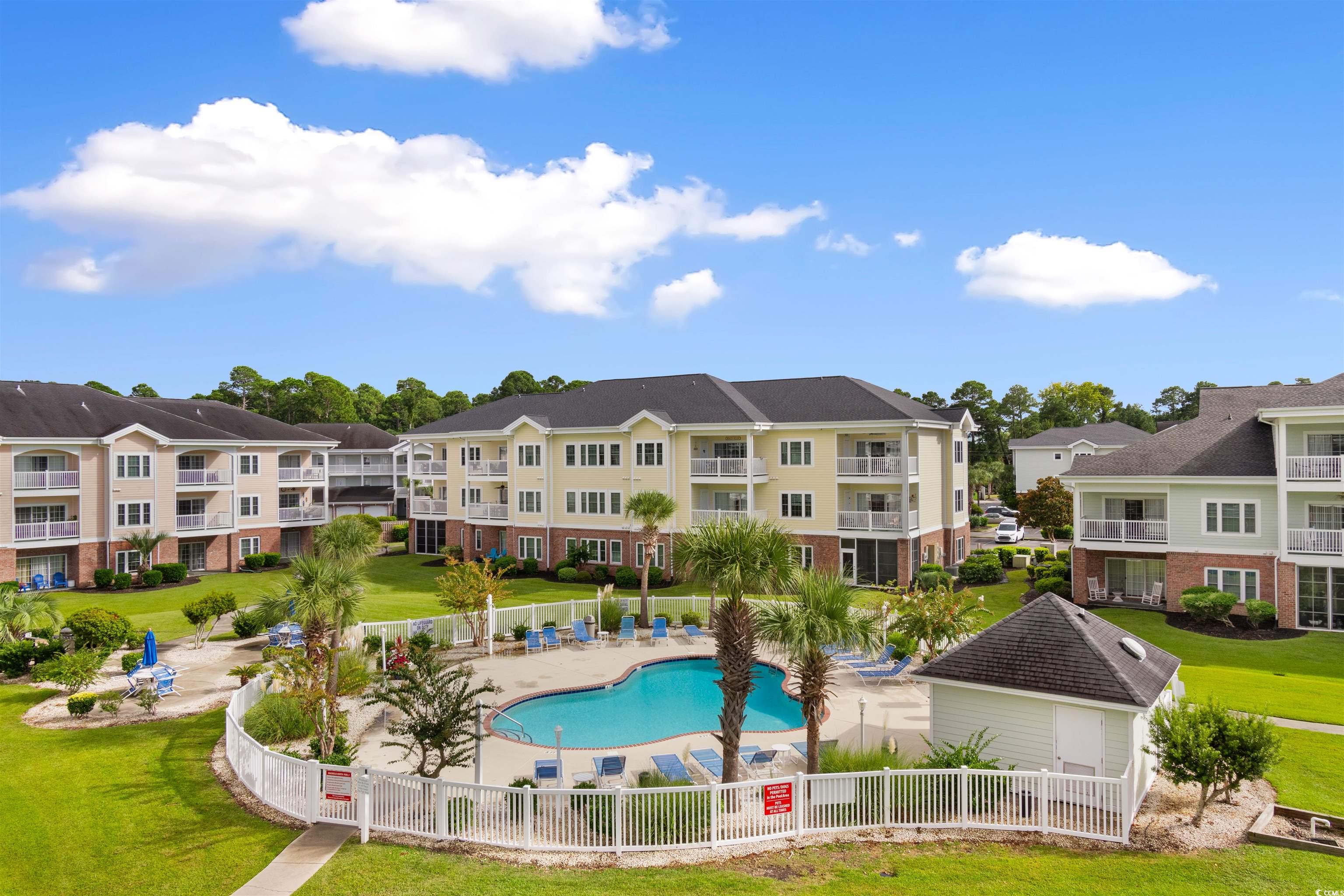 4856 Carnation Circle, Unit 302 Myrtle Beach, SC 29577 - Photo 12 of 28 Community pool featuring a patio area