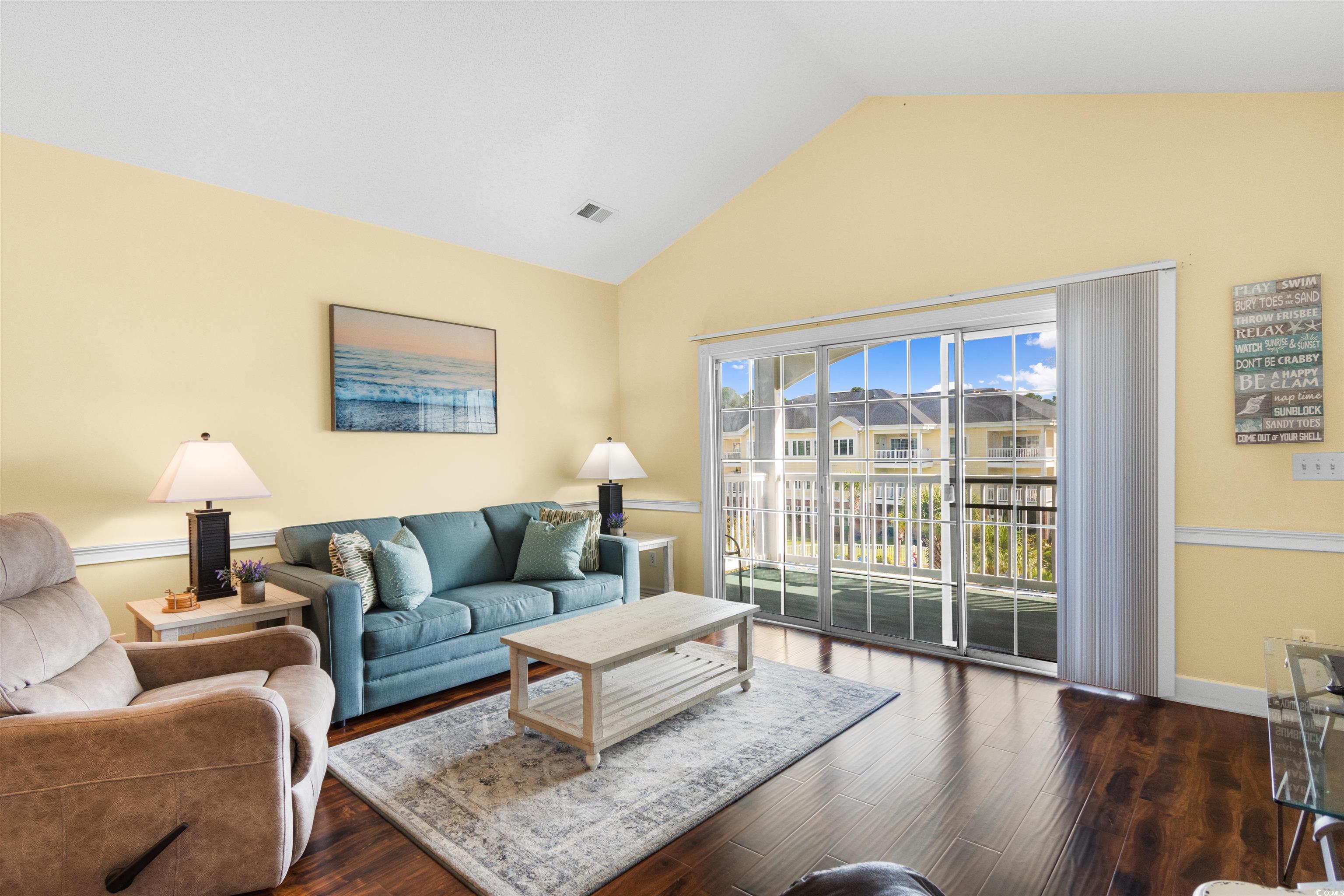 4856 Carnation Circle, Unit 302 Myrtle Beach, SC 29577 - Photo 19 of 28 Living area featuring lofted ceiling and dark wood-type flooring