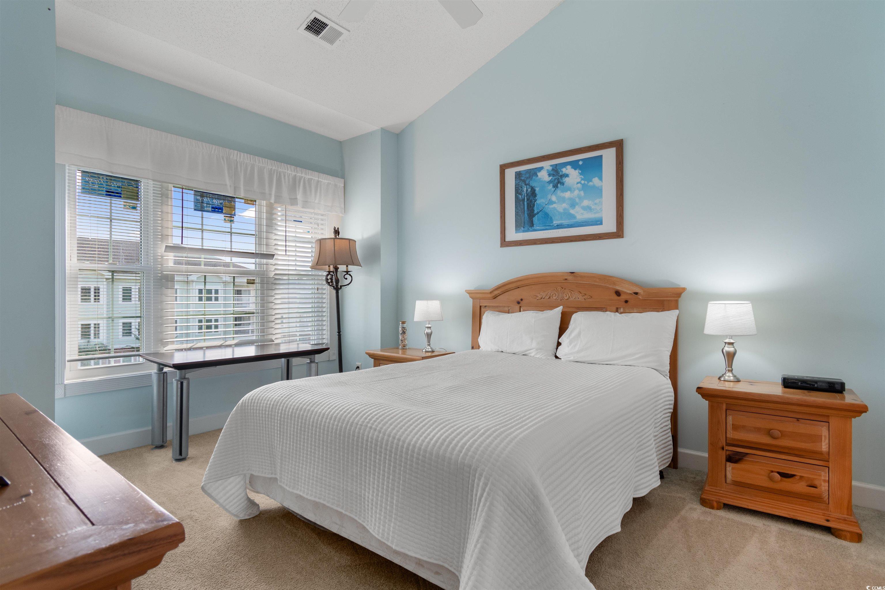 4856 Carnation Circle, Unit 302 Myrtle Beach, SC 29577 - Photo 21 of 28 Carpeted bedroom with vaulted ceiling and a ceiling fan