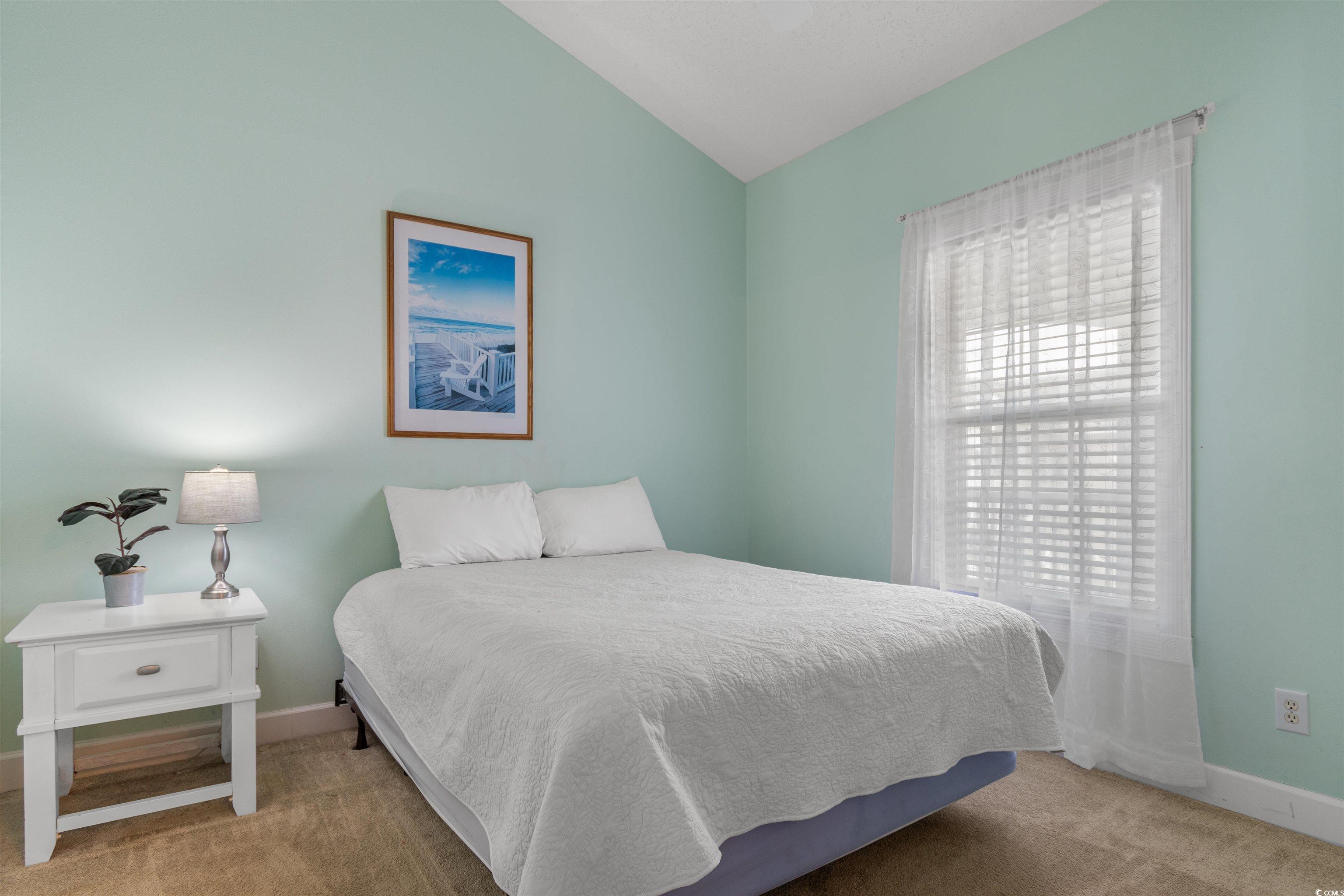 4856 Carnation Circle, Unit 302 Myrtle Beach, SC 29577 - Photo 22 of 28 Bedroom with light colored carpet and lofted ceiling