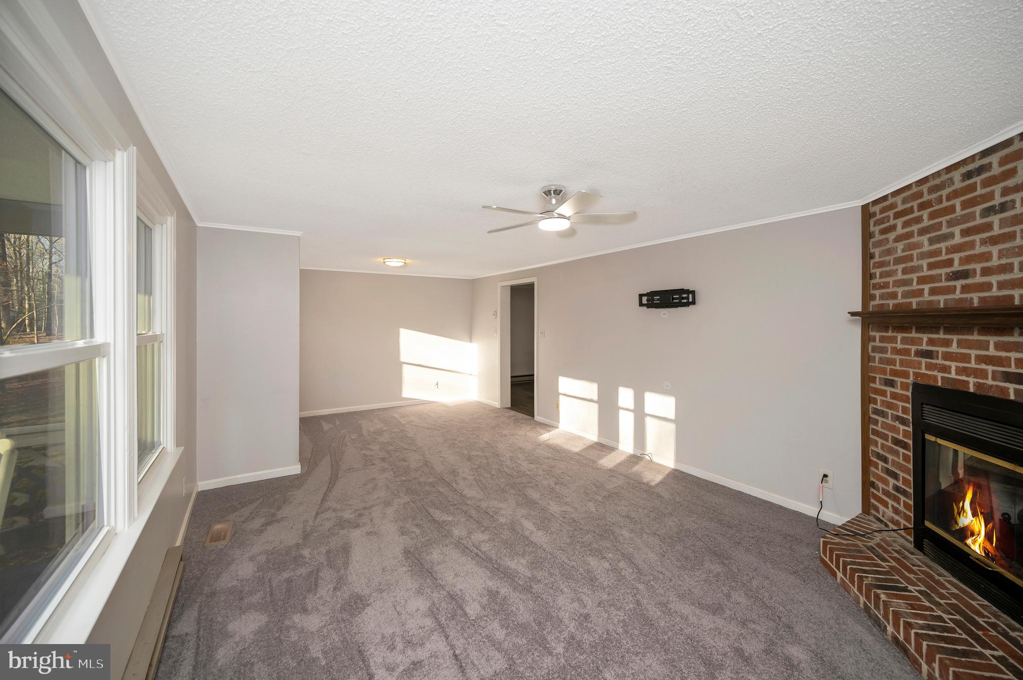 12402 Toll House Road Spotsylvania, VA 22551 - Photo 11 of 59 a view of empty room with window and fireplace