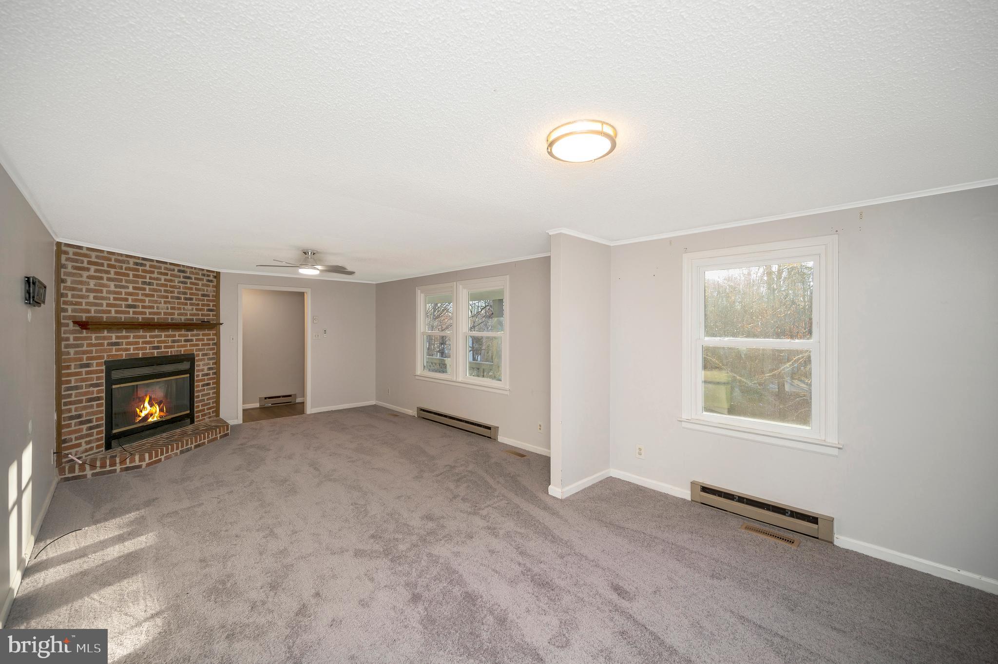 12402 Toll House Road Spotsylvania, VA 22551 - Photo 14 of 59 an empty room with windows and fireplace