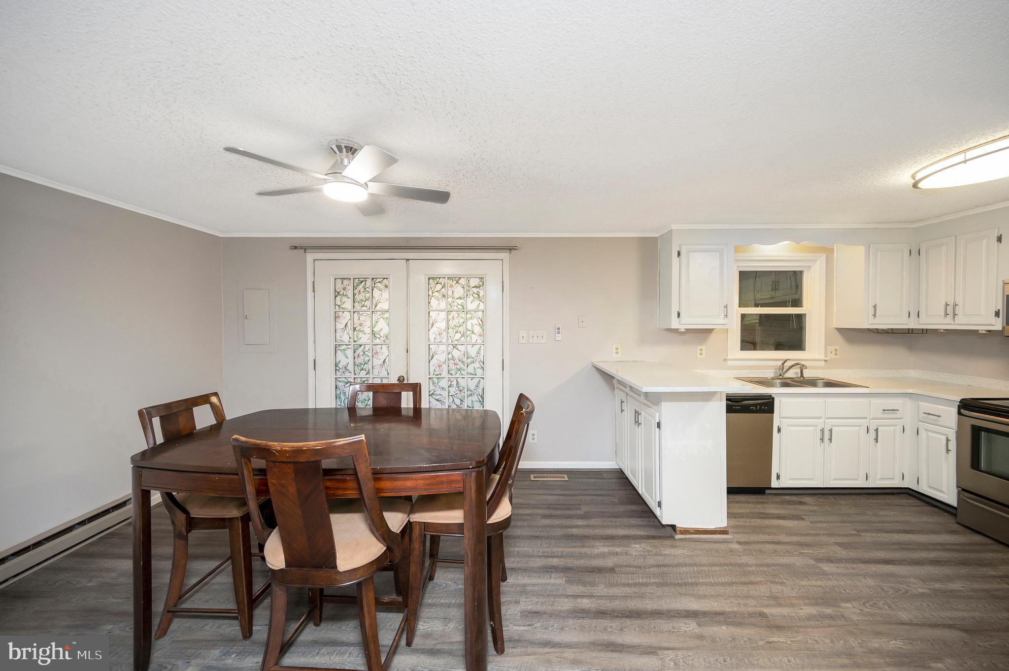 12402 Toll House Road Spotsylvania, VA 22551 - Photo 15 of 59 a view of a dining room with furniture window and wooden floor