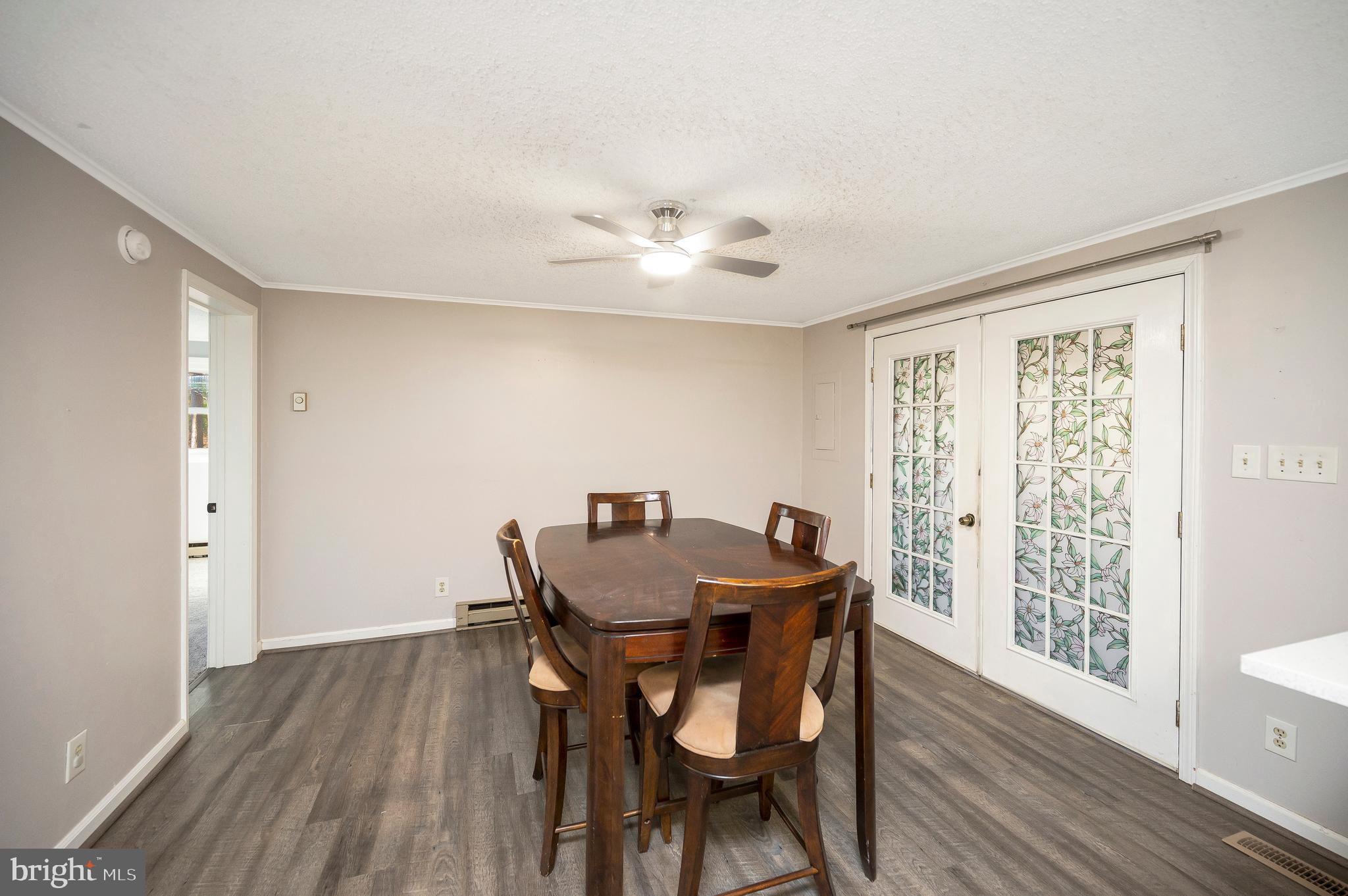 12402 Toll House Road Spotsylvania, VA 22551 - Photo 16 of 59 a view of a dining room with furniture window and wooden floor