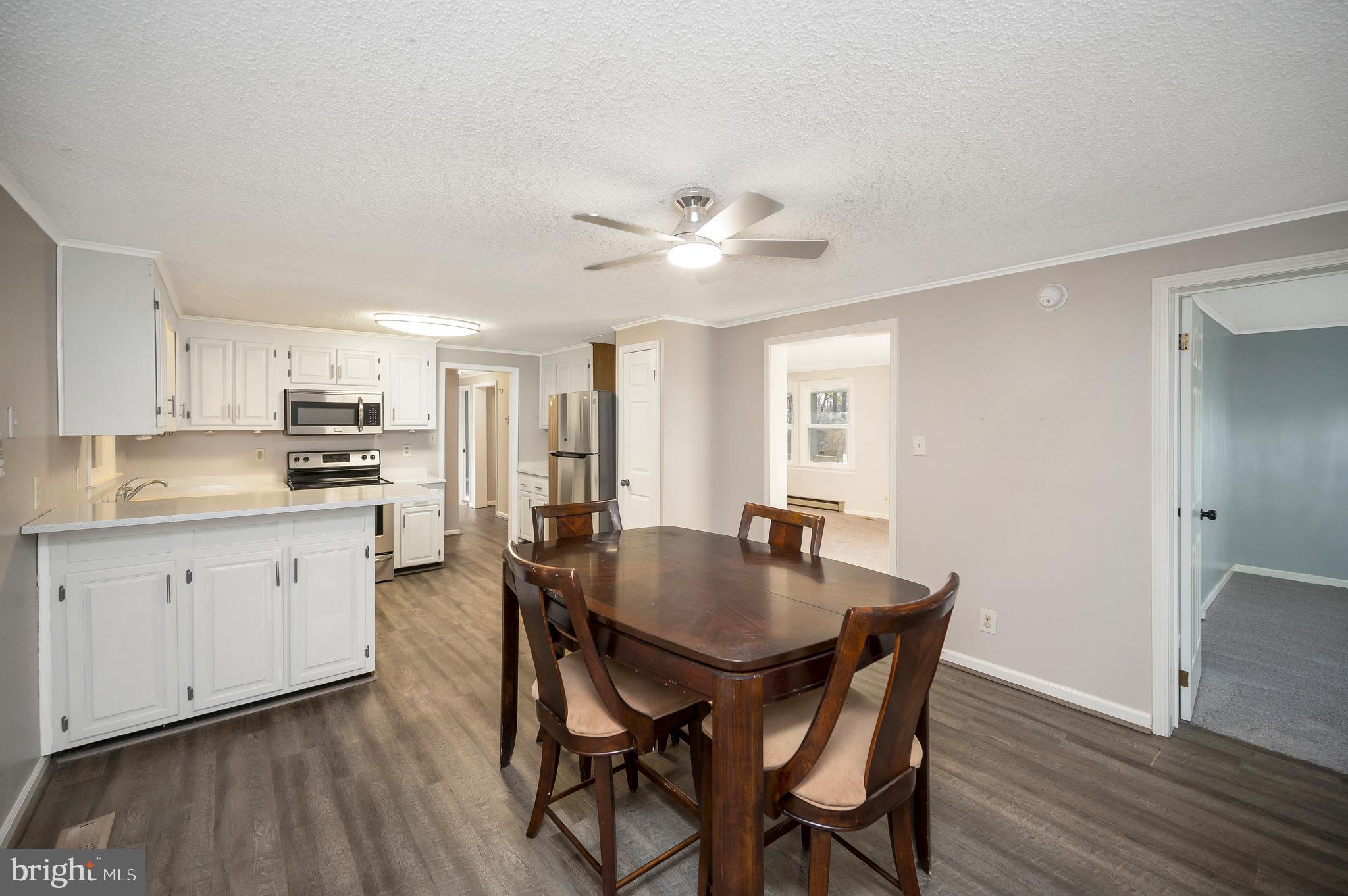 12402 Toll House Road Spotsylvania, VA 22551 - Photo 17 of 59 a view of kitchen with cabinets table and chairs