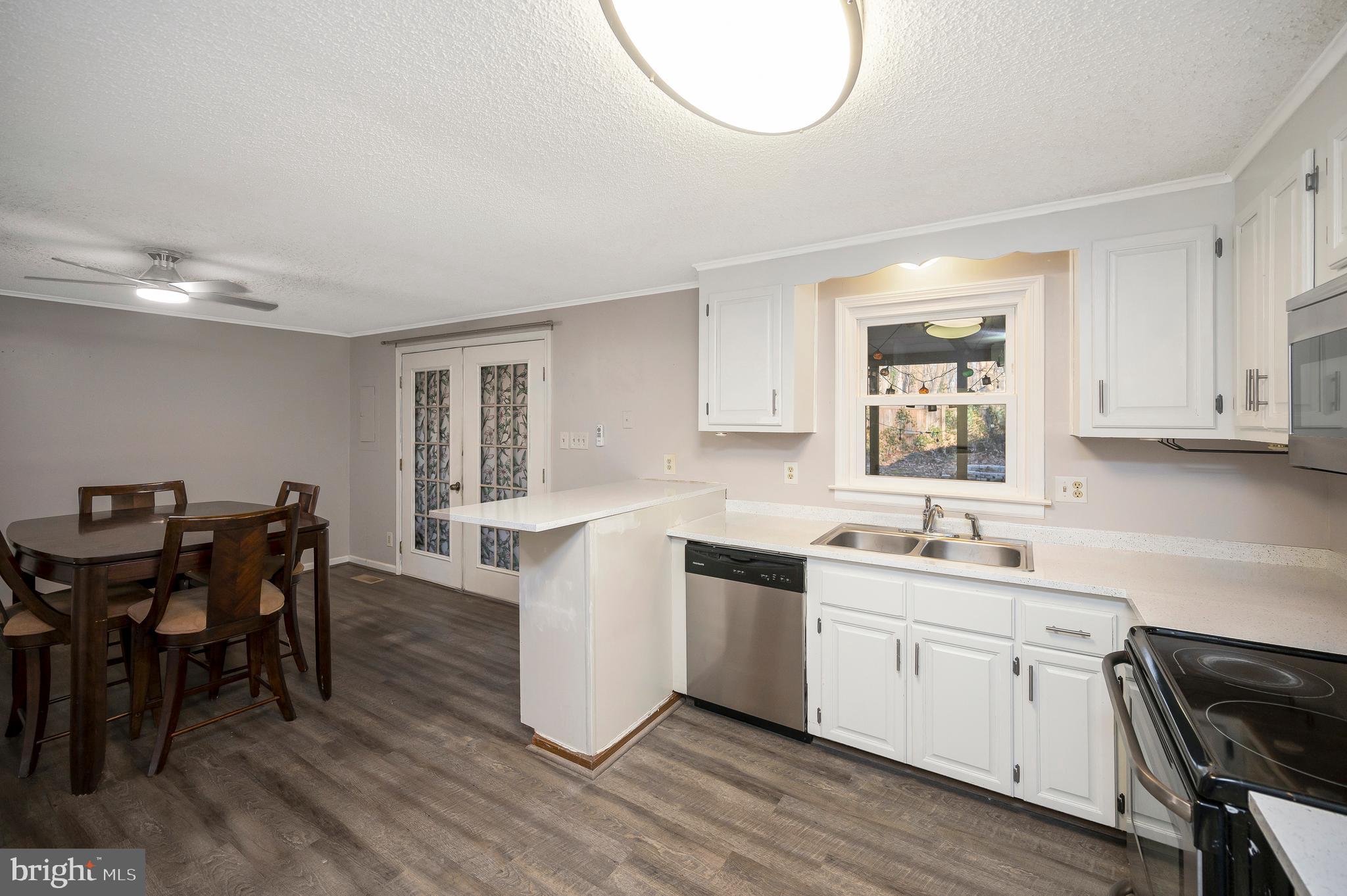 12402 Toll House Road Spotsylvania, VA 22551 - Photo 21 of 59 a kitchen with a sink cabinets and dining table chair