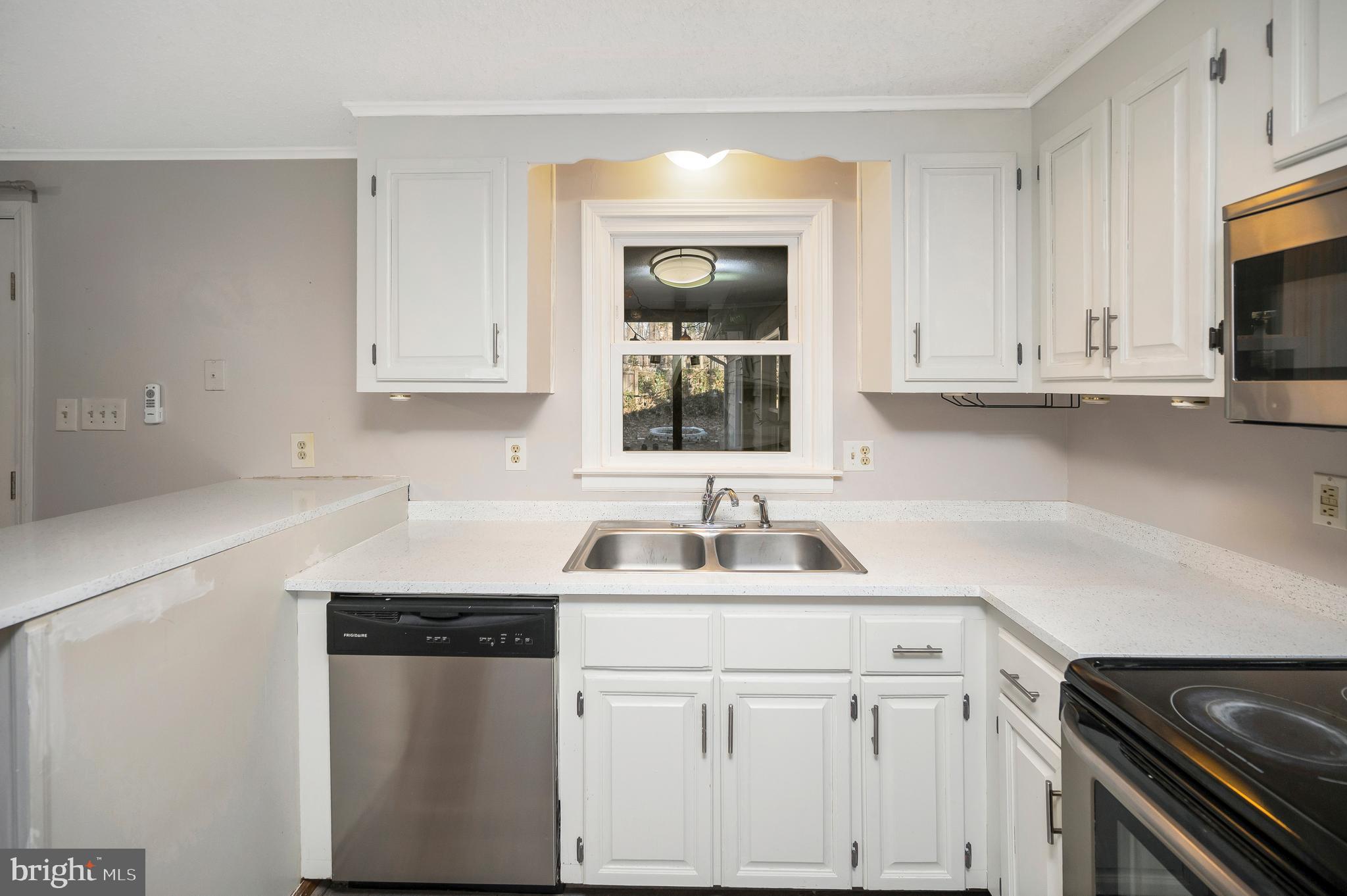 12402 Toll House Road Spotsylvania, VA 22551 - Photo 22 of 59 a kitchen with white cabinets and a sink