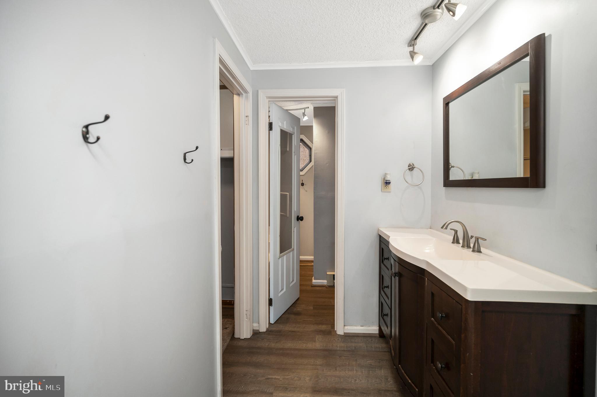 12402 Toll House Road Spotsylvania, VA 22551 - Photo 28 of 59 a bathroom with a sink a mirror and a toilet