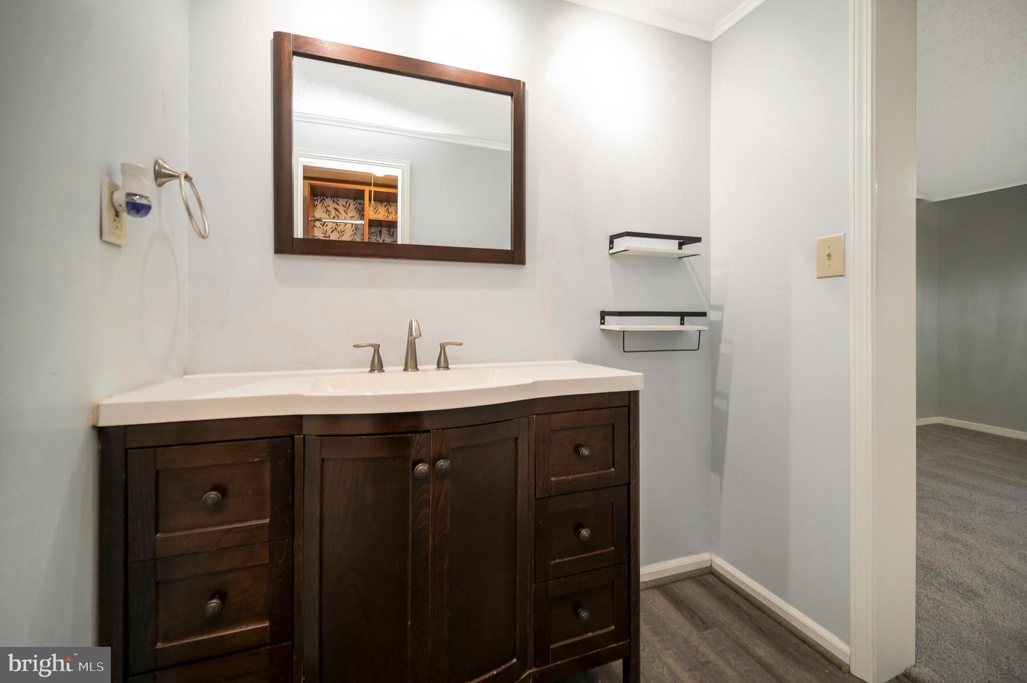 12402 Toll House Road Spotsylvania, VA 22551 - Photo 30 of 59 a bathroom with a sink vanity and mirror