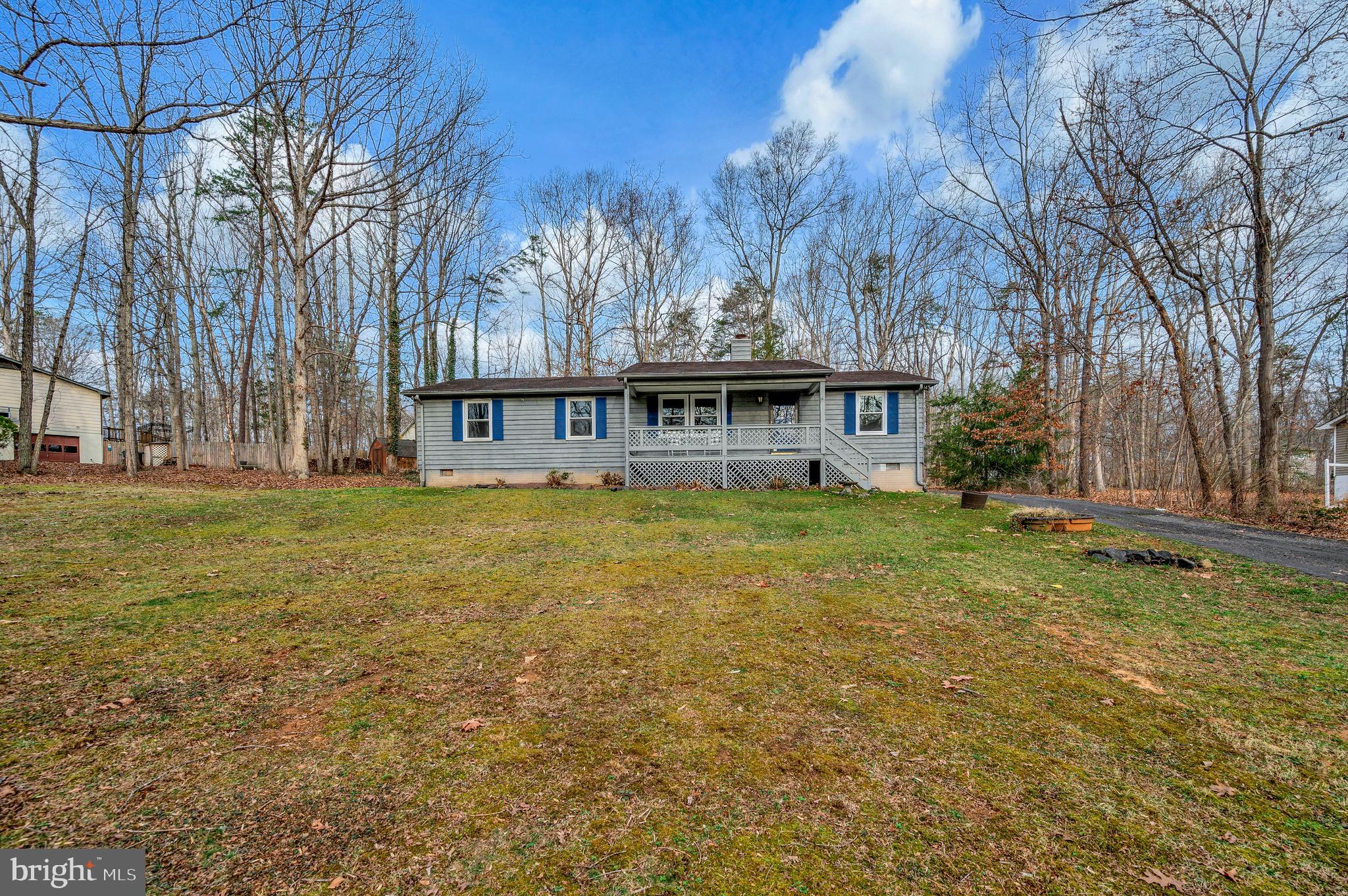 12402 Toll House Road Spotsylvania, VA 22551 - Photo 3 of 59 a view of a house with a yard and trees