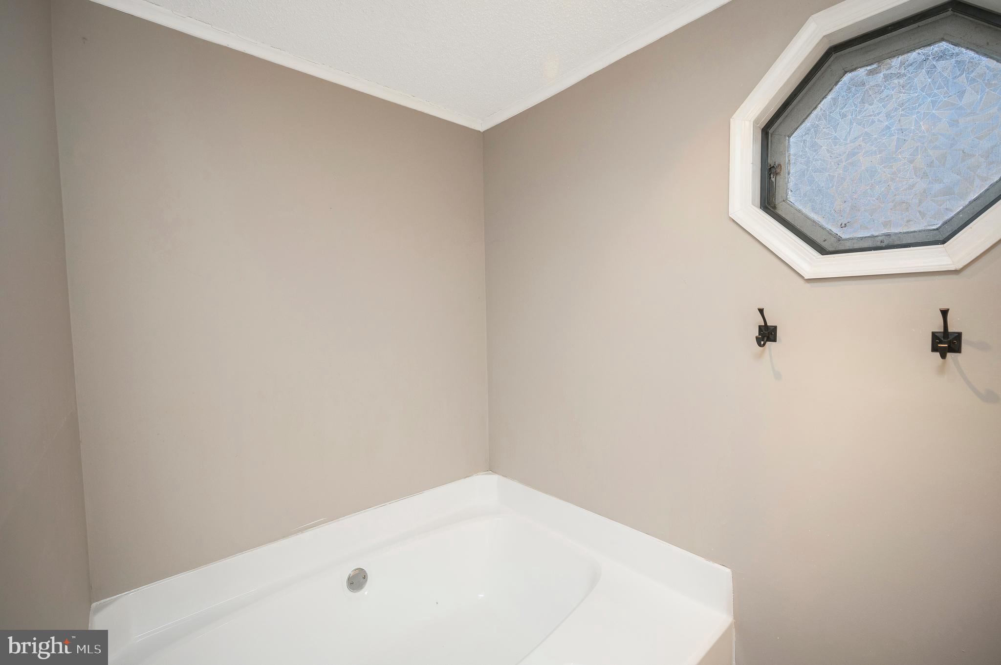 12402 Toll House Road Spotsylvania, VA 22551 - Photo 31 of 59 a bathroom with a white tub and a mirror