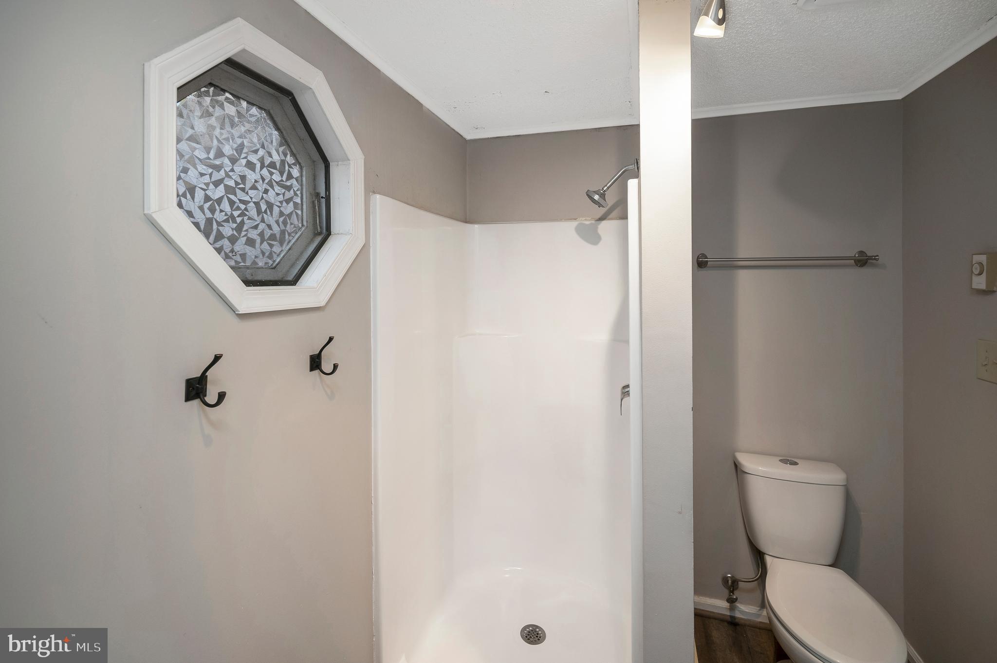 12402 Toll House Road Spotsylvania, VA 22551 - Photo 32 of 59 a bathroom with a toilet and a shower