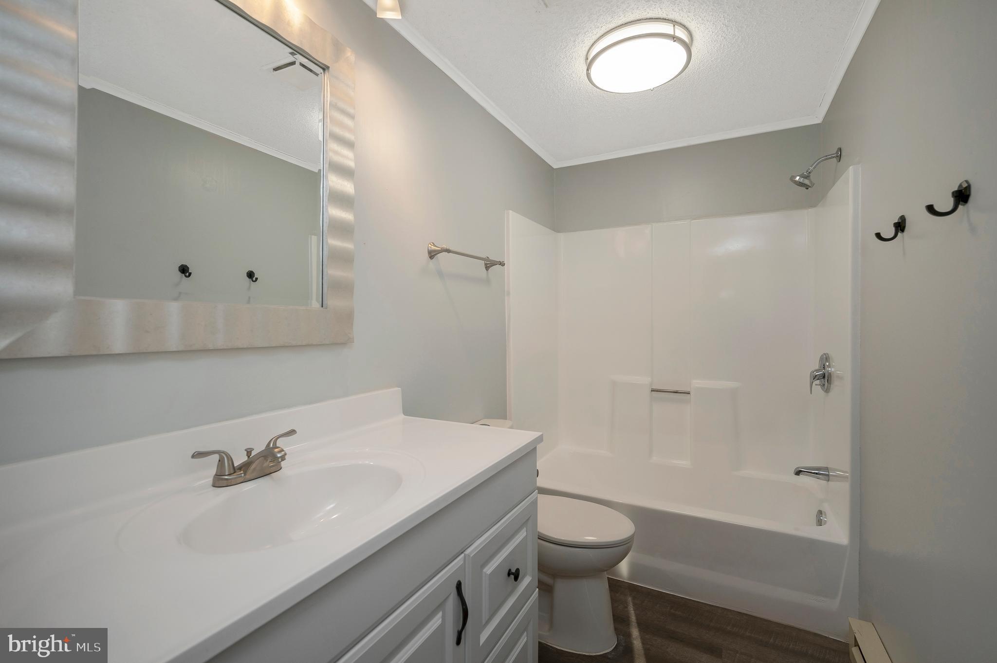 12402 Toll House Road Spotsylvania, VA 22551 - Photo 38 of 59 a bathroom with a sink and a mirror