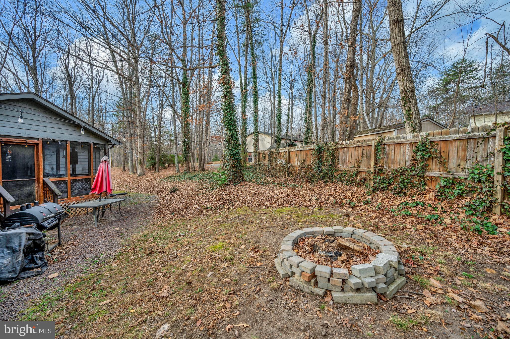 12402 Toll House Road Spotsylvania, VA 22551 - Photo 55 of 59 a backyard of a house with barbeque oven table and chairs