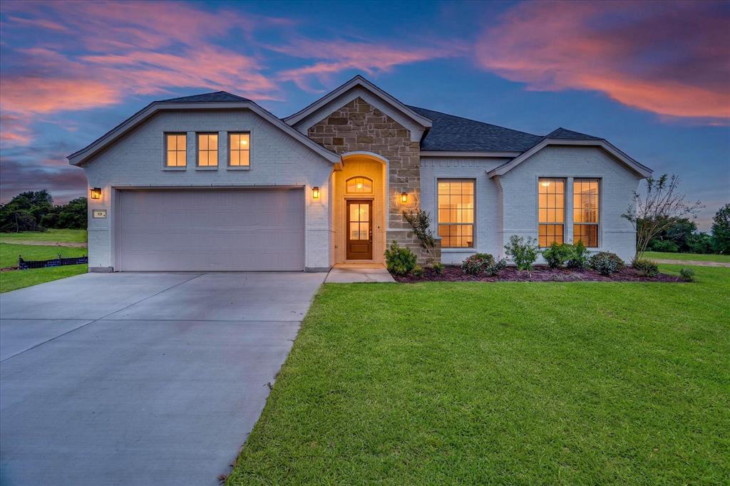 321 Skeen Peak Springtown, TX 76082 - Photo 3 of 37 Contemporary single-story home featuring a white brick exterior with stone accents