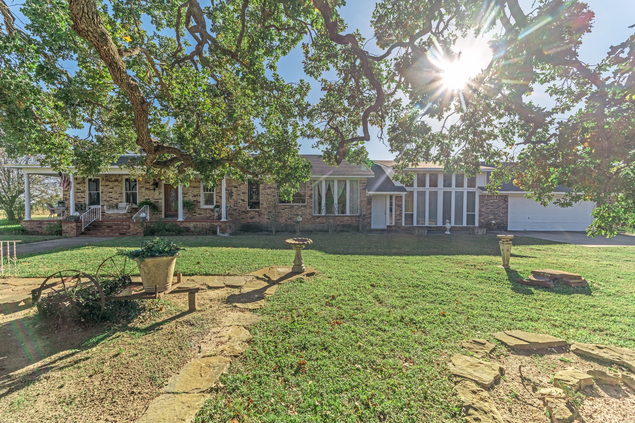 a view of a house with backyard and sitting area