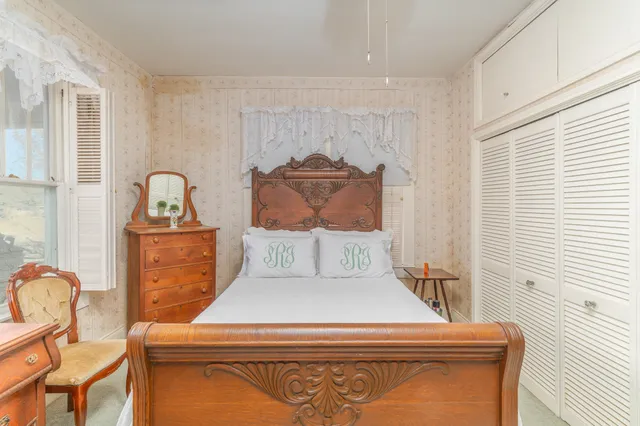 a bedroom with a bed and a chandelier