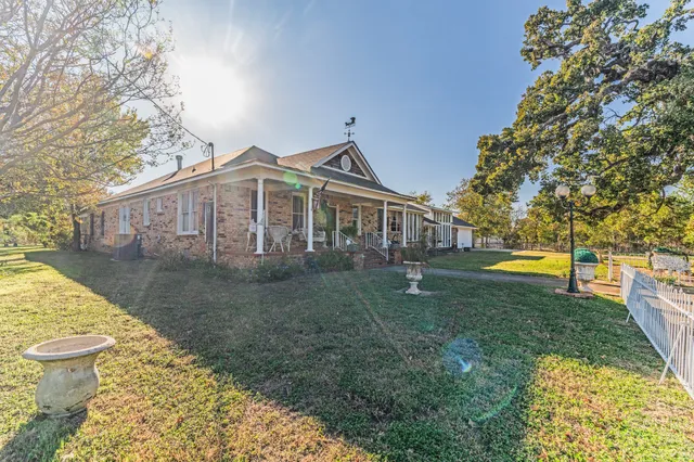 a view of a house with a yard and sitting area