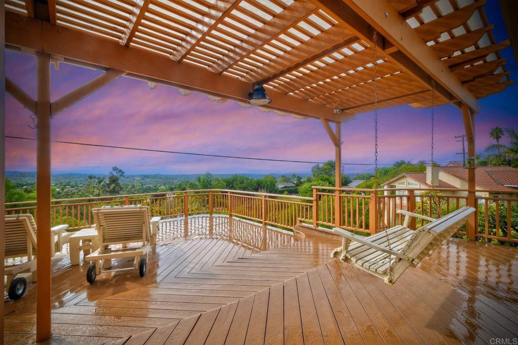 a view of a balcony with wooden floor and outdoor seating