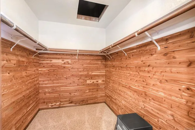 a bathroom with a granite countertop tub sink and mirror