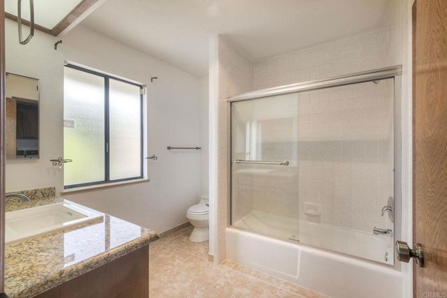 a utility room with sink dryer and washer