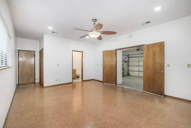 a bathroom with a granite countertop sink a toilet and mirror